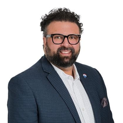 Portrait of the real estate agent Nader Omar of Remax Nova standing confidently outdoors